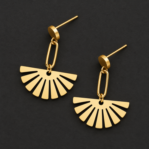 Gold fan drop earrings with geometric ray cutout pendant on a dark background