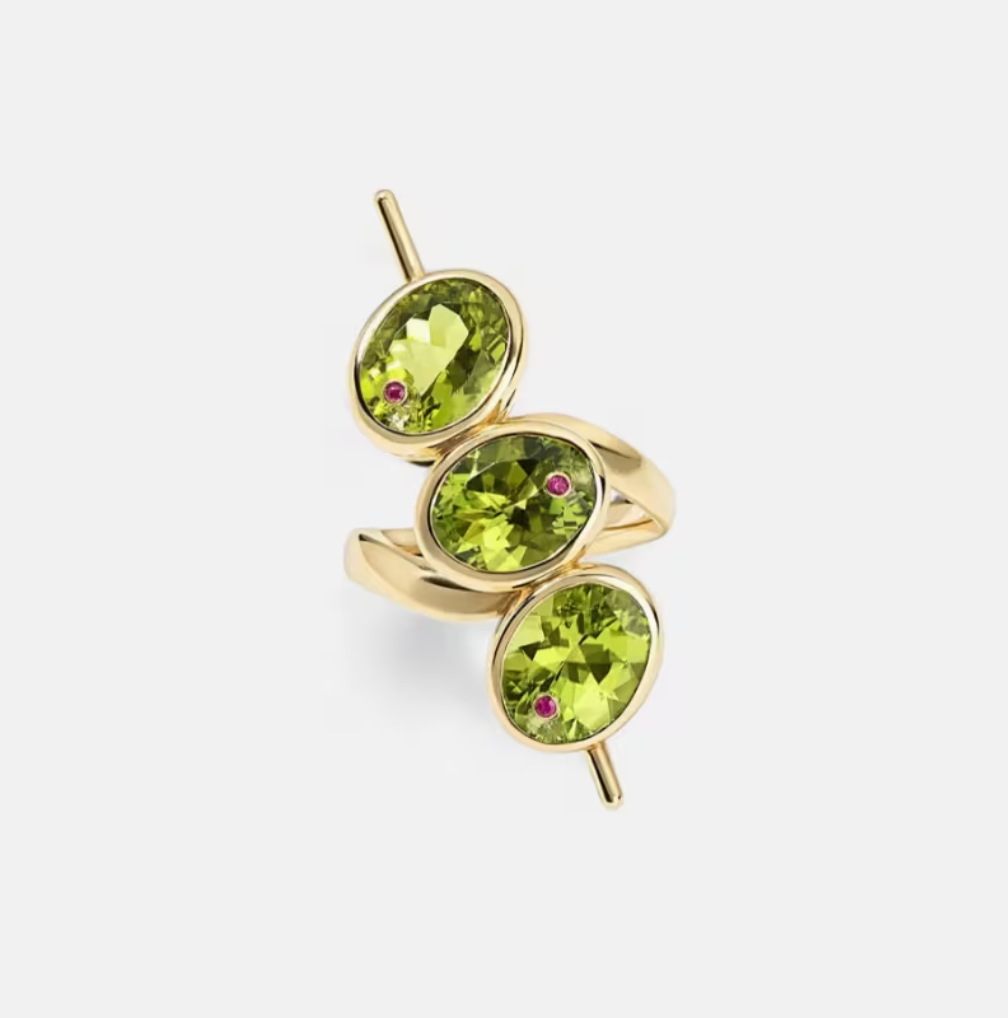 The Dirty Martini Ring — three oval green synthetic zircon stones in gold bezel settings on a cocktail pick-style ring, product shot